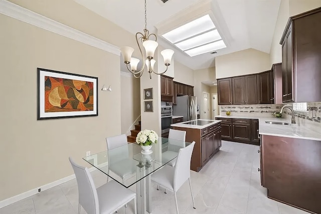 kitchen with stainless steel appliances, lofted ceiling, a sink, an inviting chandelier, and a center island