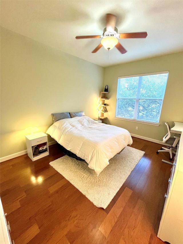 bedroom with ceiling fan and dark hardwood / wood-style flooring