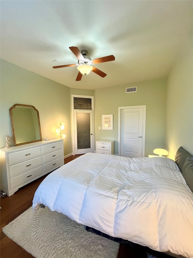 bedroom featuring ceiling fan and dark hardwood / wood-style floors