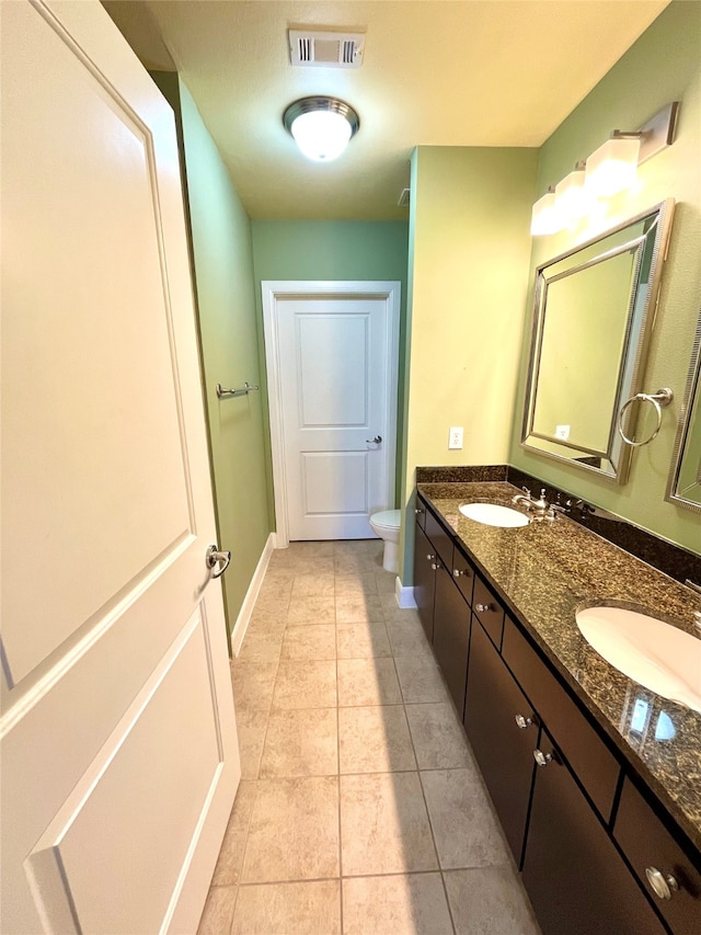 bathroom with tile patterned floors, toilet, and vanity