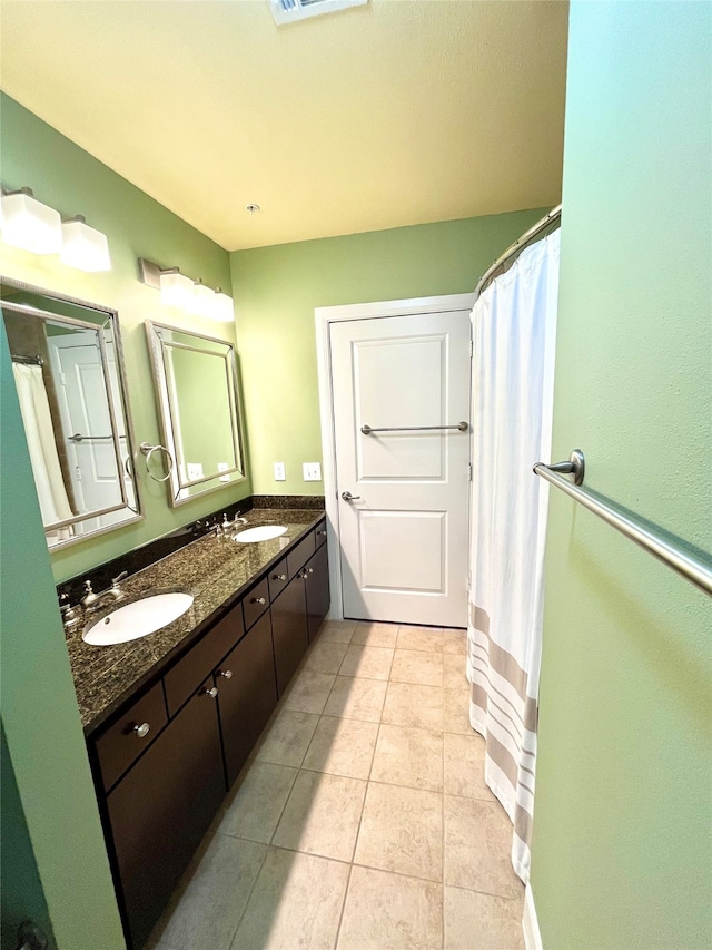 bathroom featuring vanity, curtained shower, and tile patterned floors