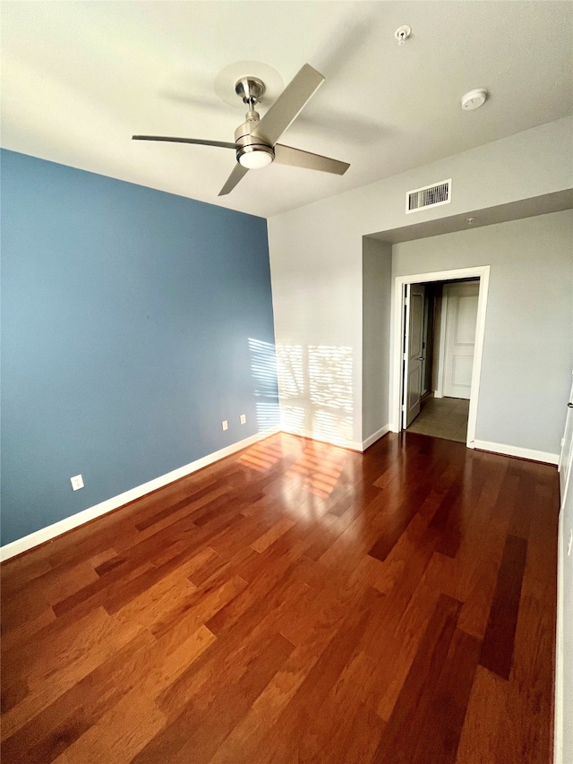 unfurnished bedroom featuring ceiling fan, dark hardwood / wood-style floors, and a closet