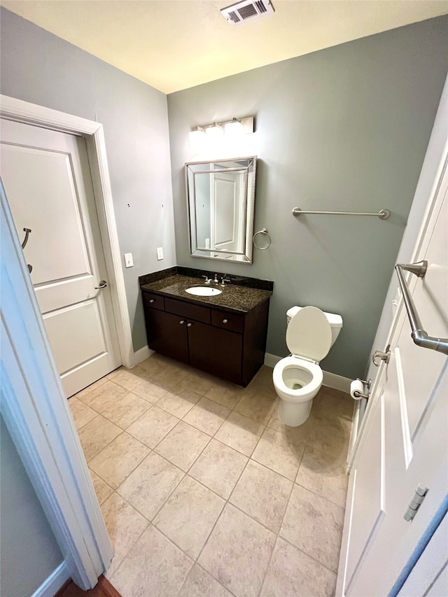 bathroom featuring tile patterned floors, toilet, and vanity