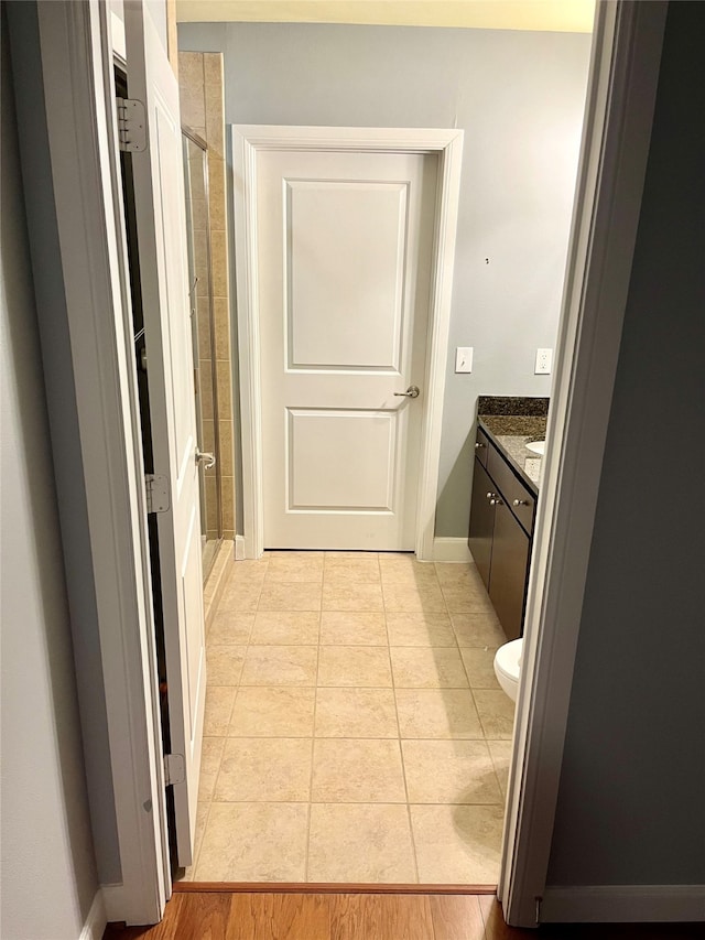 bathroom with a shower with door, vanity, toilet, and hardwood / wood-style floors