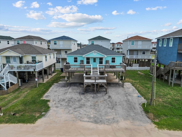 rear view of property with a carport and a yard