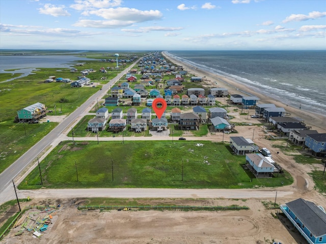 bird's eye view featuring a water view and a view of the beach