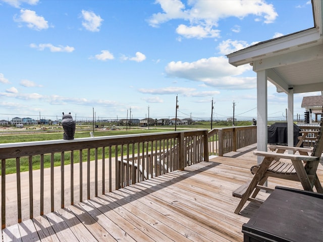 wooden deck featuring a lawn