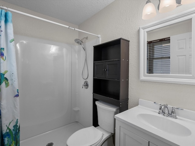 bathroom with a textured wall, toilet, a shower with shower curtain, a textured ceiling, and vanity