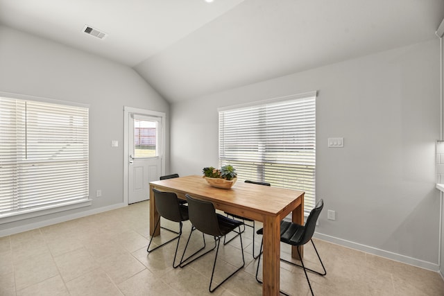 dining room featuring lofted ceiling and light tile patterned floors