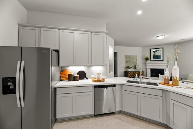 kitchen featuring gray cabinetry, appliances with stainless steel finishes, light tile patterned floors, and sink