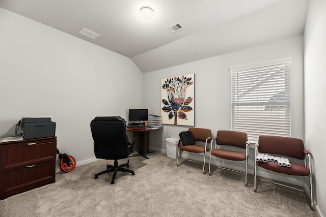 carpeted office space featuring vaulted ceiling