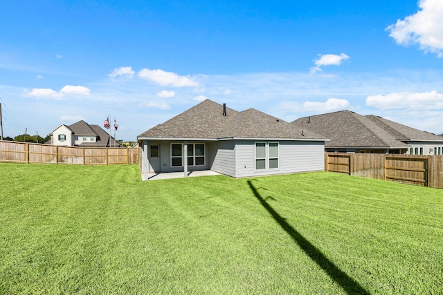 back of property with a patio and a yard