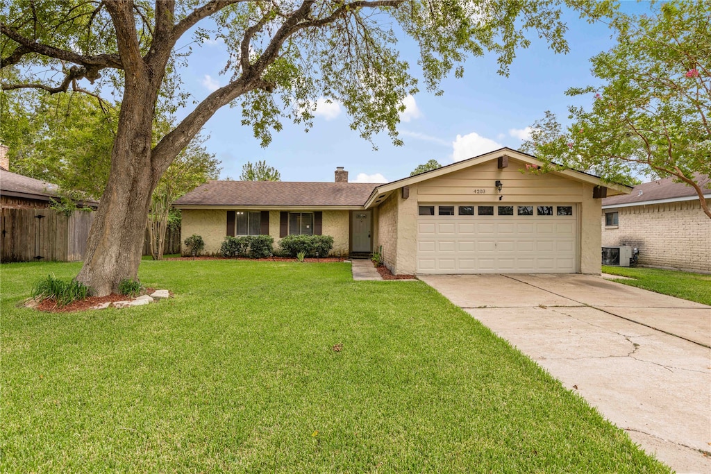 ranch-style home with a garage and a front lawn