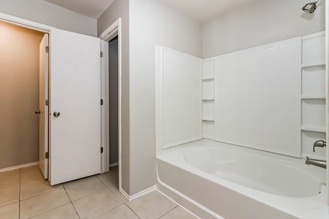 bathroom with tile patterned flooring and bathing tub / shower combination