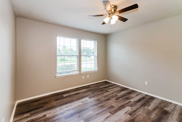 empty room featuring dark wood-type flooring and ceiling fan