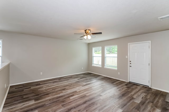 unfurnished room featuring dark hardwood / wood-style flooring and ceiling fan