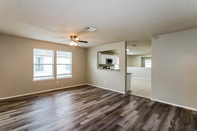 interior space featuring dark wood-type flooring and ceiling fan