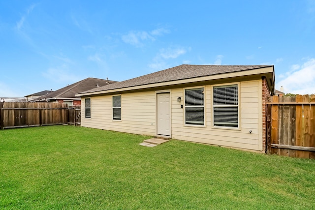 back of house with a yard