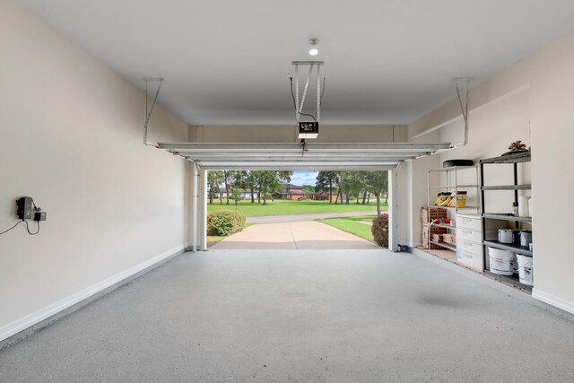 garage featuring a garage door opener and a lawn