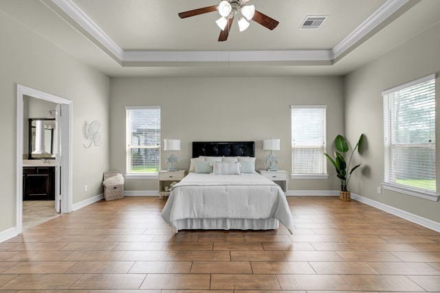 bedroom featuring connected bathroom, ceiling fan, light wood-type flooring, and crown molding