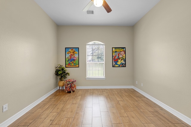 empty room featuring light wood-type flooring and ceiling fan