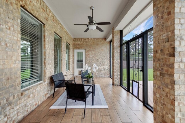 sunroom / solarium featuring ceiling fan and a healthy amount of sunlight