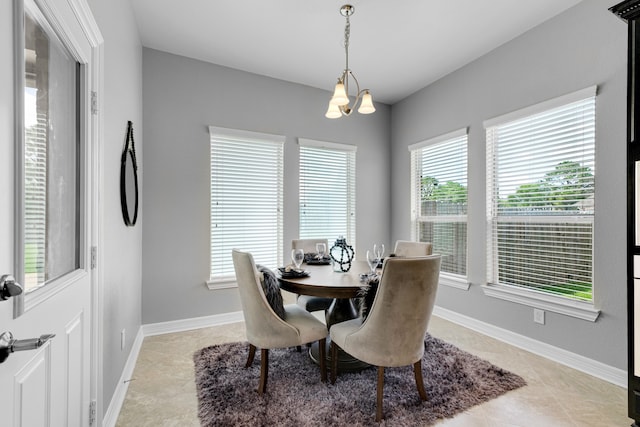 tiled dining space with a chandelier