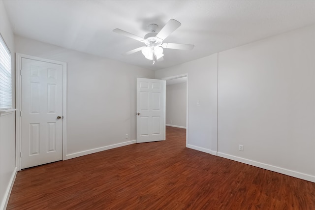 spare room featuring ceiling fan and dark hardwood / wood-style flooring