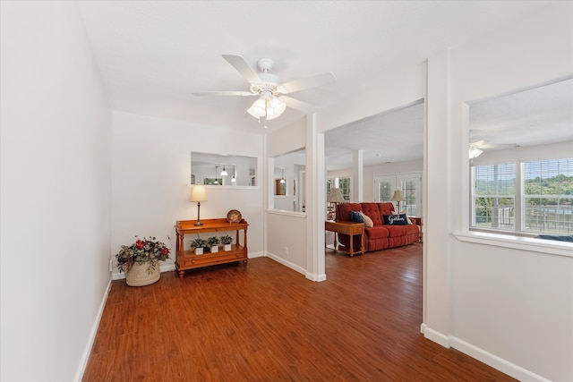 sitting room with hardwood / wood-style floors and ceiling fan