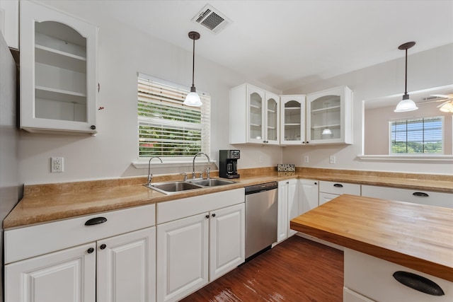 kitchen with white cabinets, dark wood-type flooring, sink, pendant lighting, and dishwasher