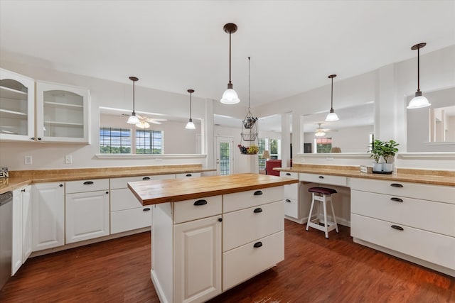 kitchen featuring dark hardwood / wood-style floors, a kitchen island, and a wealth of natural light