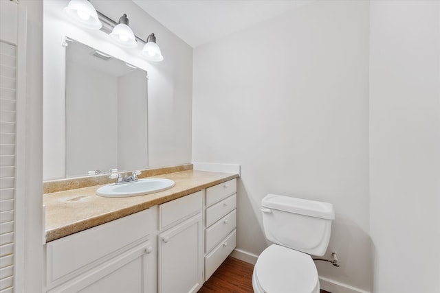 bathroom featuring hardwood / wood-style flooring, vanity, and toilet