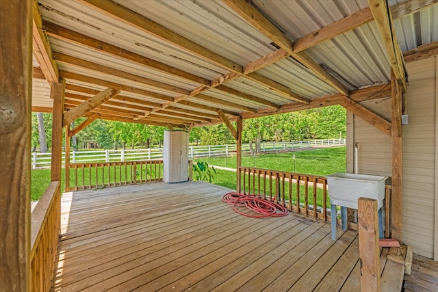 wooden terrace featuring a lawn