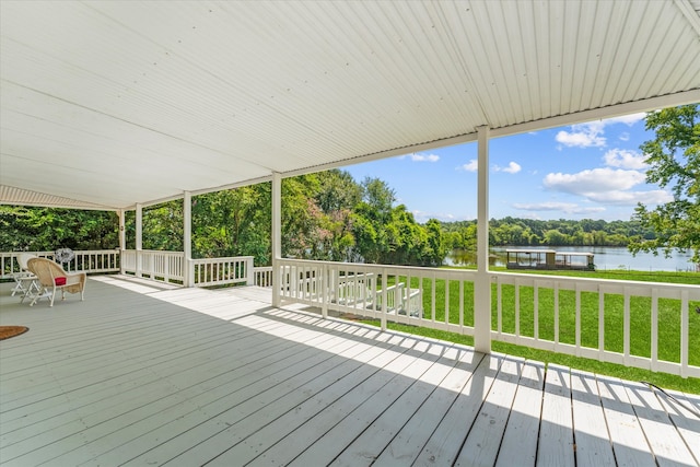 deck featuring a lawn and a water view