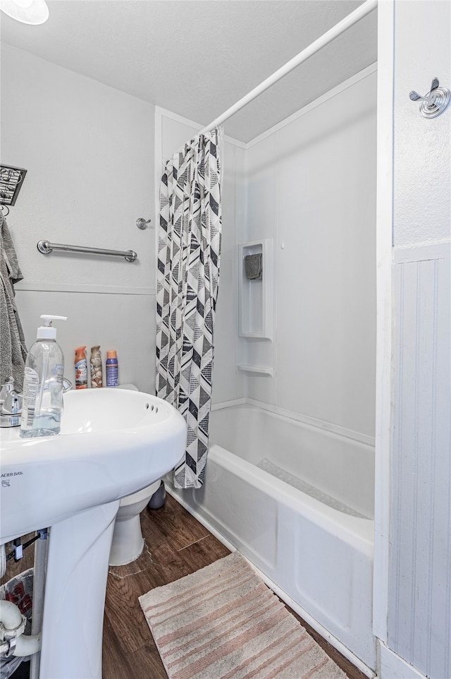 bathroom with shower / bath combo with shower curtain and hardwood / wood-style floors