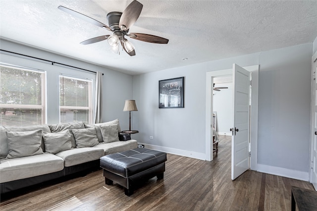 sitting room with a textured ceiling, dark wood-type flooring, and ceiling fan