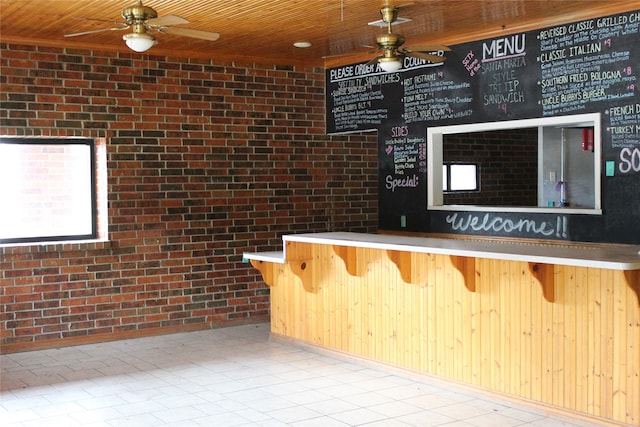 reception featuring bar area and ceiling fan