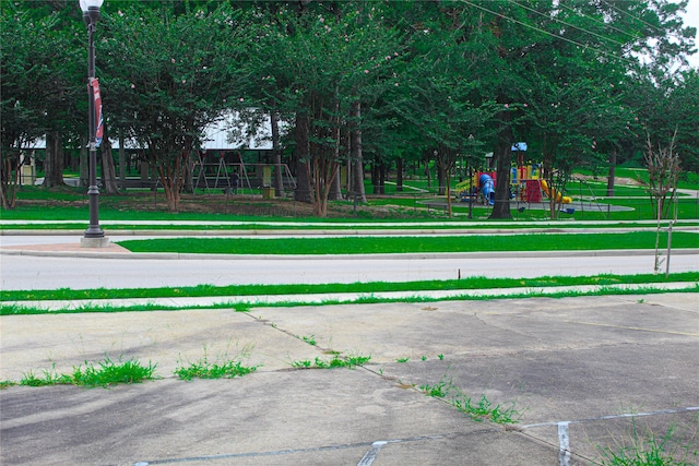 surrounding community with a playground and a yard