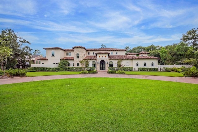 mediterranean / spanish house featuring a front lawn