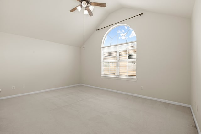 unfurnished room featuring ceiling fan, light carpet, and vaulted ceiling