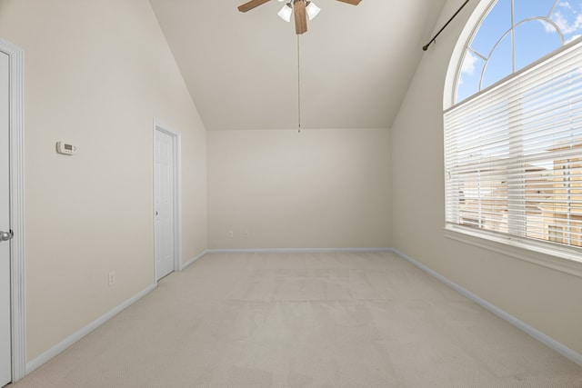 carpeted spare room featuring lofted ceiling and ceiling fan