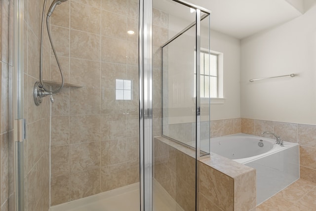 bathroom featuring shower with separate bathtub and tile patterned floors