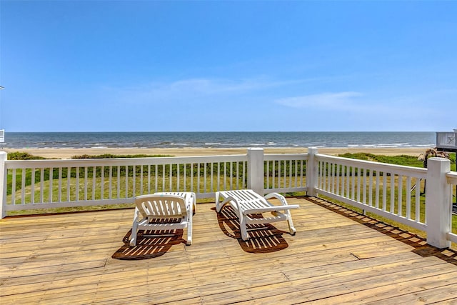 deck with a water view and a view of the beach