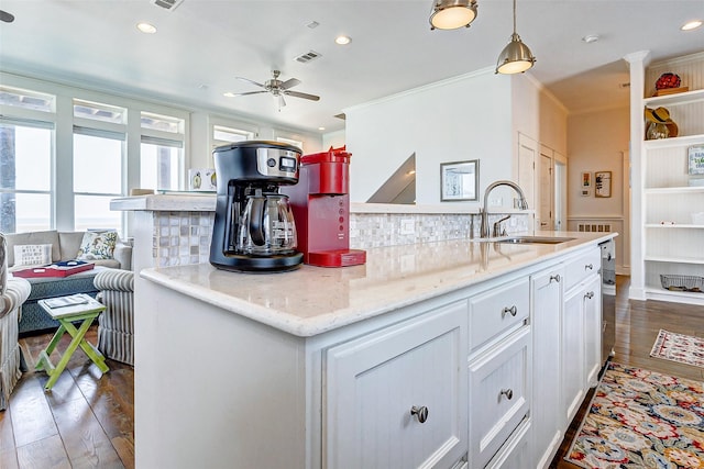 kitchen with dark wood finished floors, recessed lighting, visible vents, white cabinetry, and a sink