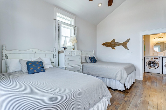 bedroom featuring ceiling fan, wood-type flooring, vaulted ceiling, and independent washer and dryer