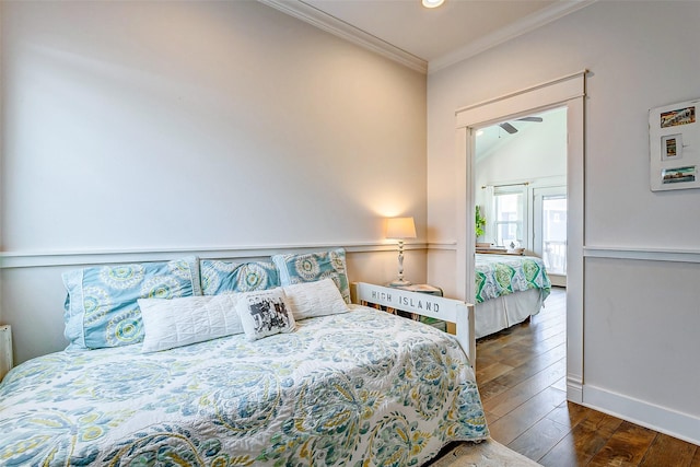 bedroom featuring baseboards, hardwood / wood-style flooring, and crown molding