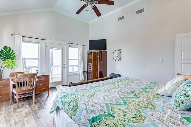 bedroom featuring light wood-style floors, access to outside, visible vents, and crown molding