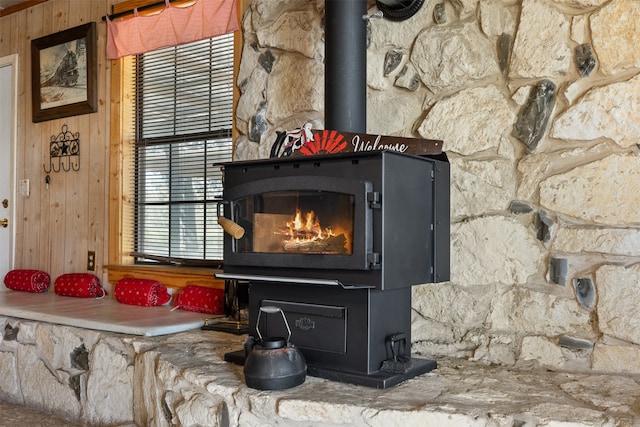 details with a wood stove and wooden walls