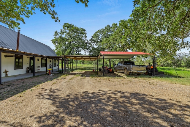 view of yard featuring a carport and covered porch