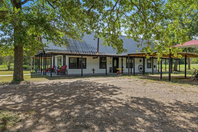 rear view of house featuring covered porch